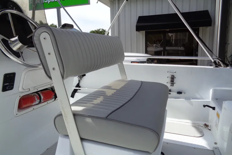 Slide: The Image of 2004 Triumph 190 Bay boat interior with gray seating and steering wheel. - 11