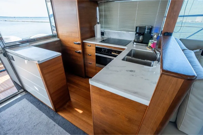 Slide: The Image of Luxurious kitchen interior of 2021 Princess S66 yacht with modern appliances and wooden cabinetry. - 18