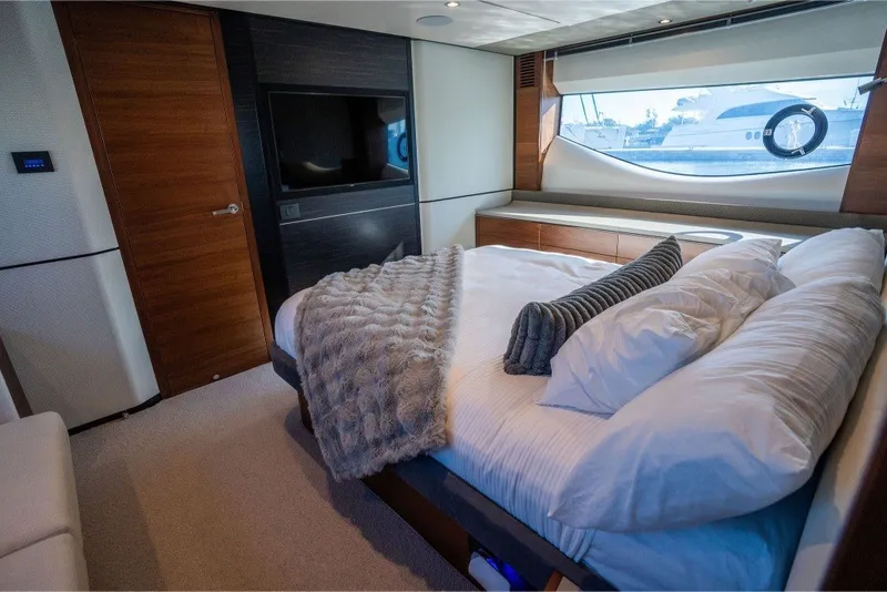 Slide: The Image of Luxurious bedroom interior of 2021 Princess S66 yacht with elegant bedding and large window view. - 27