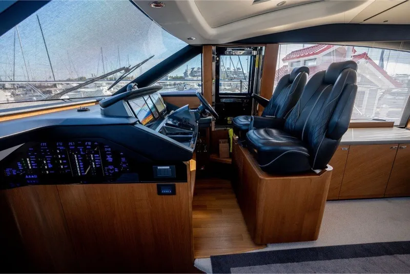 Slide: The Image of Luxurious 2021 Princess S66 yacht cockpit with leather seats and advanced navigation controls. - 23