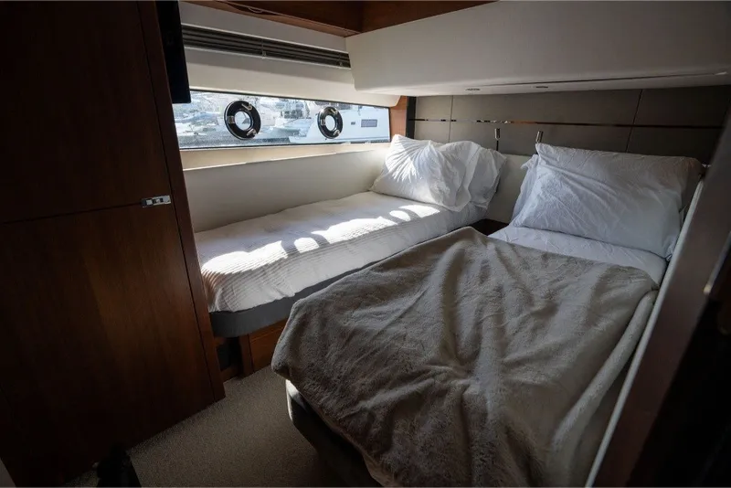 Slide: The Image of Luxurious cabin interior of 2021 Princess S66 yacht with twin beds and porthole windows. - 32