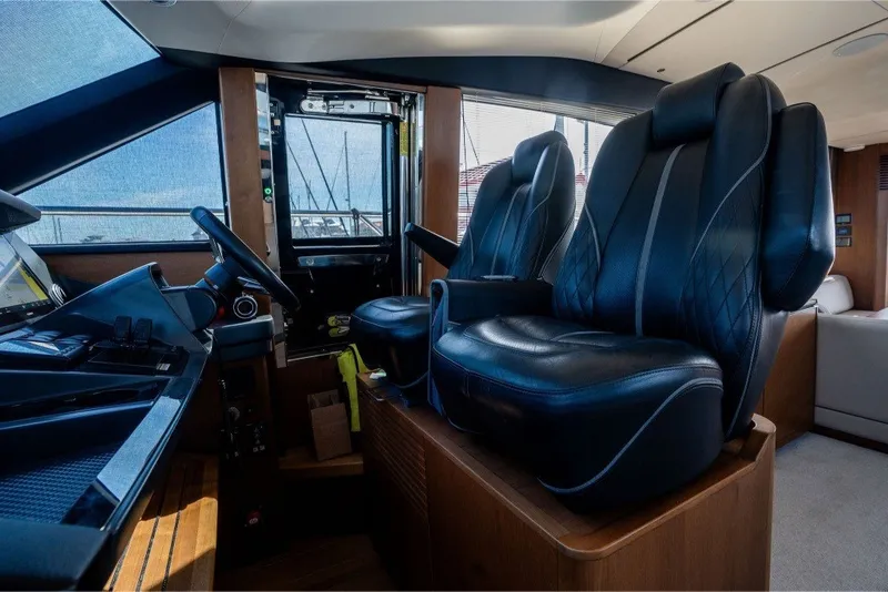 Slide: The Image of Luxurious 2021 Princess S66 yacht cockpit with leather seats and modern controls. - 24