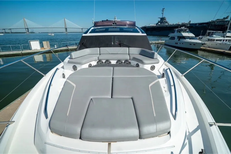 Slide: The Image of Luxury 2021 Princess S66 yacht with spacious sunbathing area, docked near a bridge. - 40