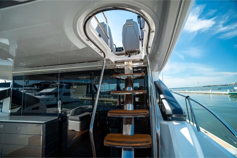 Slide: The Image of Luxurious 2021 Princess S66 yacht interior with sleek staircase and marina view. - 34
