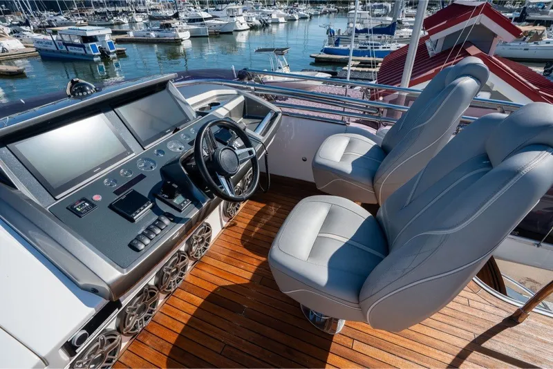 Slide: The Image of Luxurious 2021 Princess S66 yacht helm with dual seats and advanced navigation controls. - 38