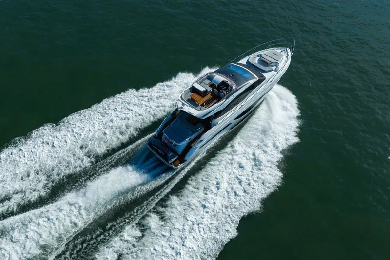 Slide: The Image of 2021 Princess S66 yacht cruising on open water, aerial view. - 13