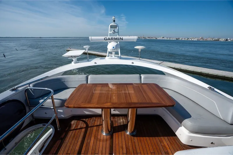 Slide: The Image of Luxurious 2021 Princess S66 yacht deck with wooden table, overlooking serene waters. - 5