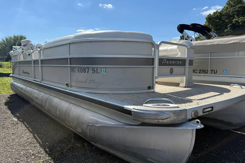 The Image of 2003 Premier 24 pontoon boat parked on a sunny day. - 0