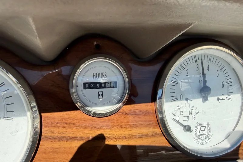 Slide: The Image of Dashboard of a 2003 Premier 24 with hour meter and RPM gauge. - 10