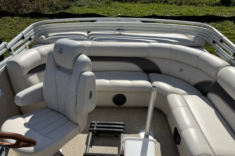 Slide: The Image of 2003 Premier 24 boat interior with plush seating and steering chair. - 12