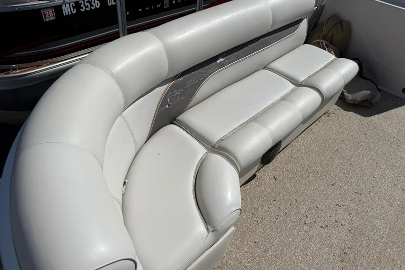 Slide: The Image of Luxurious seating on a 2003 Premier 24 boat, featuring plush white upholstery. - 6