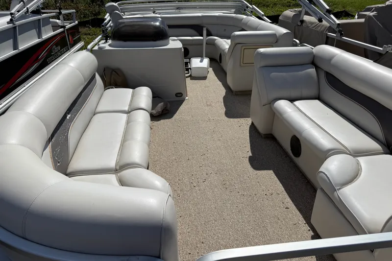 Slide: The Image of Interior of a 2003 Premier 24 boat with white cushioned seating. - 5