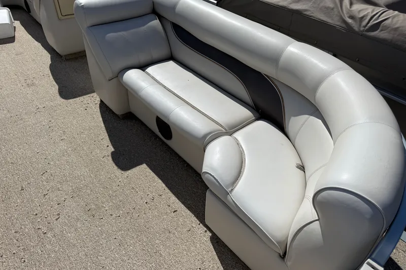 Slide: The Image of White leather seating on a 2003 Premier 24 boat, outdoor setting. - 7