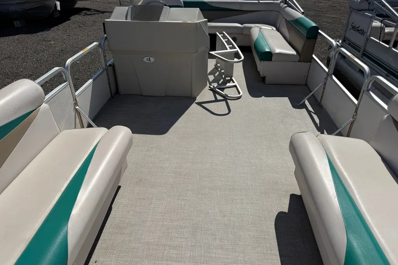 Slide: The Image of 1997 Sweetwater 24es pontoon boat interior with spacious seating and helm station. - 6