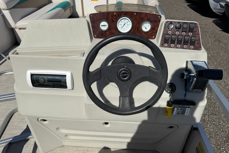Slide: The Image of Steering console of a 1997 Sweetwater 24es boat with gauges and controls. - 4