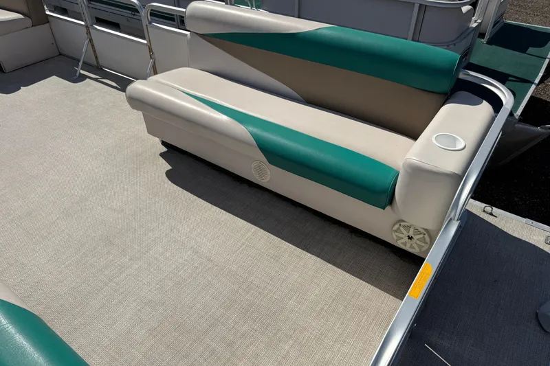 Slide: The Image of 1997 Sweetwater 24es pontoon boat interior with teal and beige seating. - 5