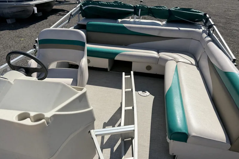 Slide: The Image of 1997 Sweetwater 24es pontoon boat interior with teal and gray seating. - 8