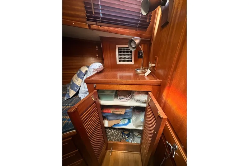 Slide: The Image of Cozy cabin interior of 1975 Gulfstar 43 Trawler with wooden storage and bedding. - 35