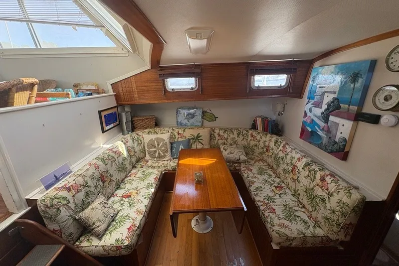 Slide: The Image of Cozy interior of 1975 Gulfstar 43 Trawler with floral upholstery and wooden table. - 17
