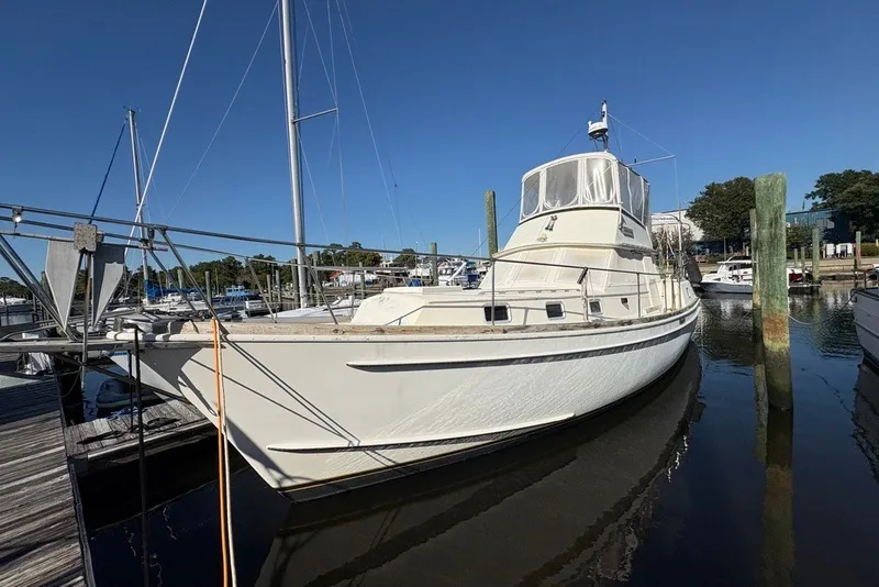 The Image of 1975 Gulfstar 43 Trawler docked at a marina under clear blue skies. - 0