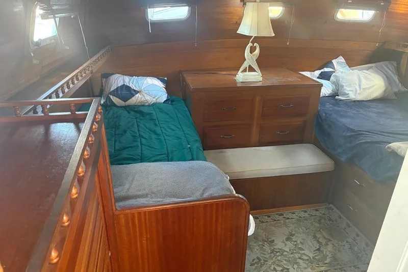 Slide: The Image of Cozy cabin interior of 1975 Gulfstar 43 Trawler with twin beds and wooden furnishings. - 49