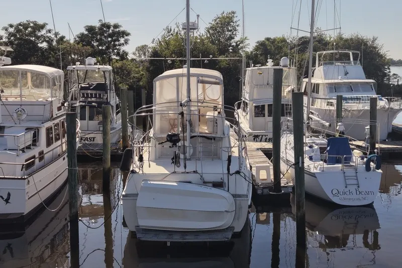 Slide: The Image of 1975 Gulfstar 43 Trawler docked among other boats in a marina setting. - 97