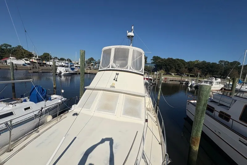 Slide: The Image of 1975 Gulfstar 43 Trawler docked at a marina under clear blue skies. - 92