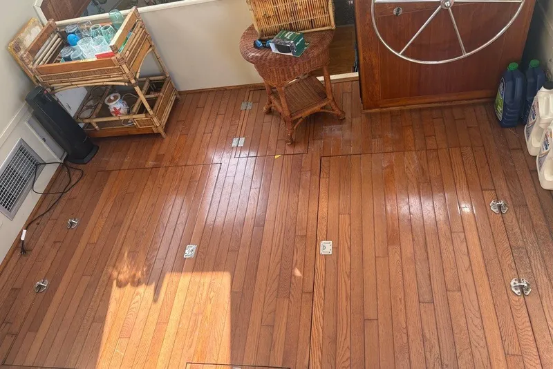 Slide: The Image of Interior of 1975 Gulfstar 43 Trawler with wooden flooring and nautical decor. - 109