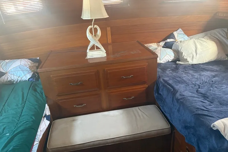 Slide: The Image of Cozy cabin interior of 1975 Gulfstar 43 Trawler with wooden dresser and twin beds. - 63