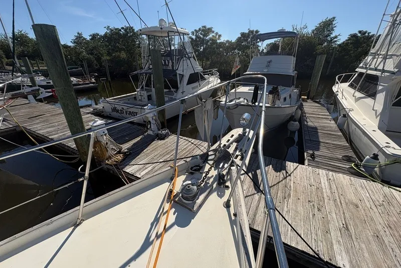 Slide: The Image of 1975 Gulfstar 43 Trawler docked among other boats at a marina. - 88