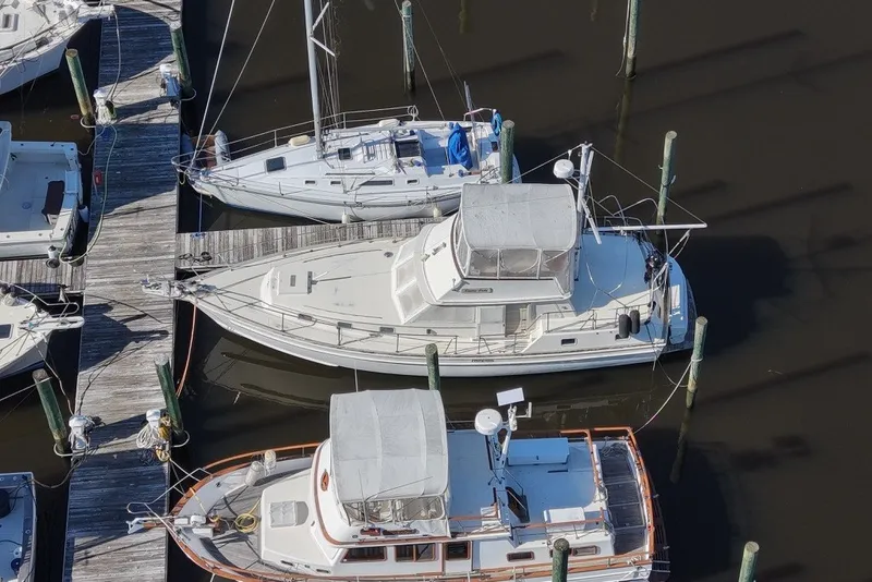 Slide: The Image of Aerial view of a 1975 Gulfstar 43 Trawler docked at a marina. - 95