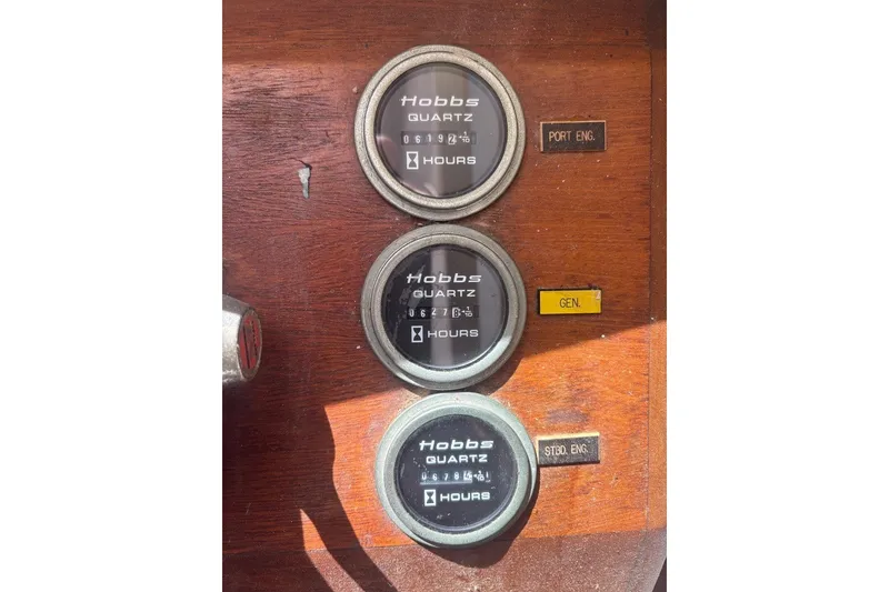 Slide: The Image of Hour meters on a 1975 Gulfstar 43 Trawler dashboard, showing engine and generator hours. - 13