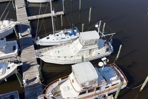 Slide: The Image of 1975 Gulfstar 43 Trawler docked at marina, aerial view. - 99