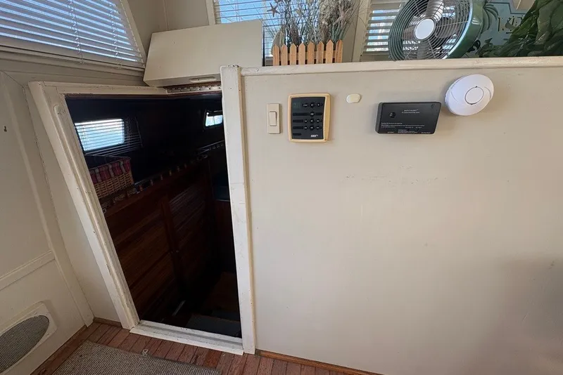 Slide: The Image of Interior view of a 1975 Gulfstar 43 Trawler, featuring a cabin entrance and control panels. - 48