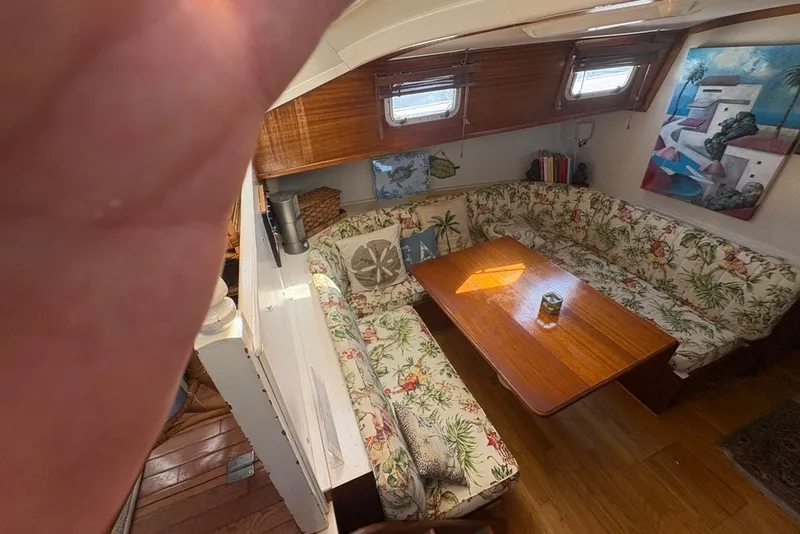Slide: The Image of Interior of 1975 Gulfstar 43 Trawler with floral upholstery and wooden table. - 22