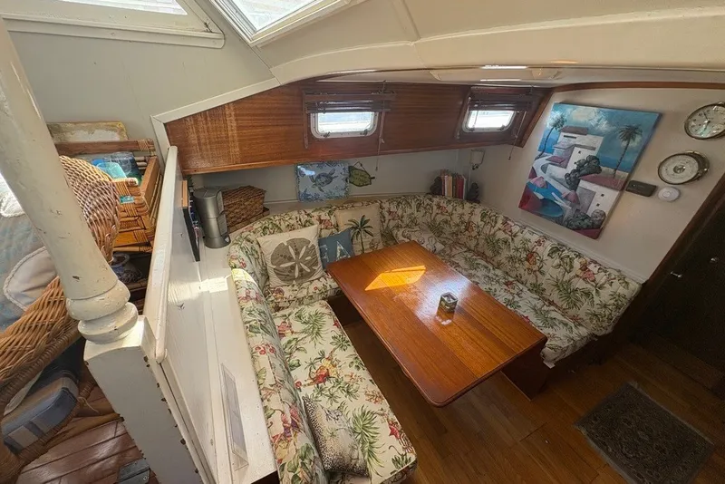 Slide: The Image of Interior of 1975 Gulfstar 43 Trawler with floral upholstery and wooden table. - 23