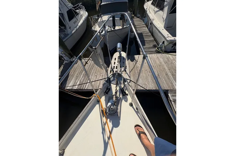 Slide: The Image of 1975 Gulfstar 43 Trawler docked, view from bow with anchor and deck details. - 89