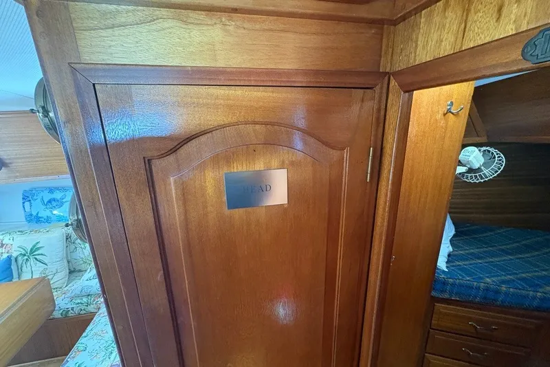 Slide: The Image of Interior of 1975 Gulfstar 43 Trawler with wooden cabinetry and cozy sleeping area. - 27