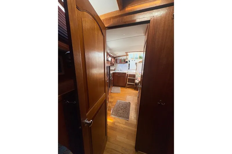 Slide: The Image of Interior view of 1975 Gulfstar 43 Trawler, featuring wooden cabinetry and flooring. - 36