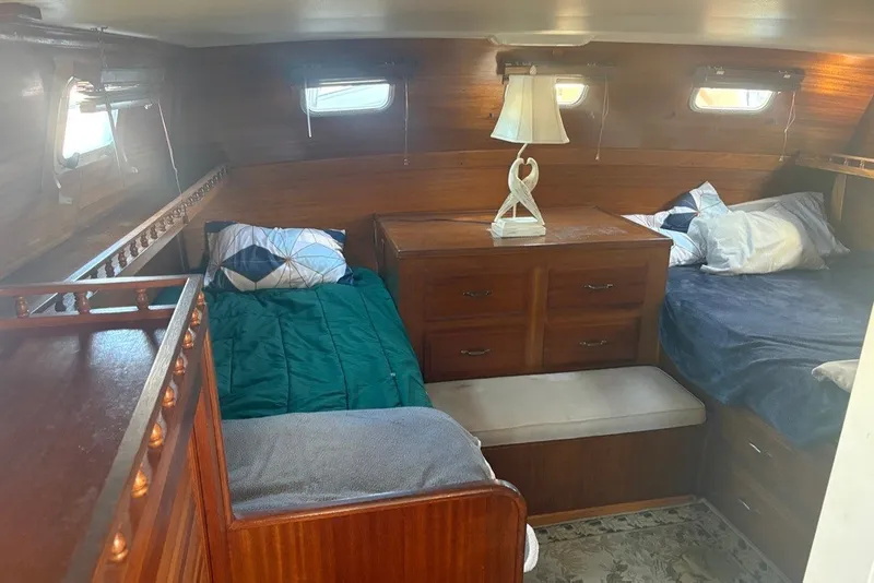 Slide: The Image of Cozy cabin interior of 1975 Gulfstar 43 Trawler with twin beds and wooden furnishings. - 50