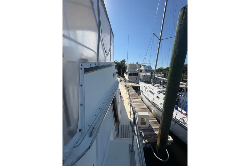 Slide: The Image of 1975 Gulfstar 43 Trawler docked at marina, side view with clear sky. - 81