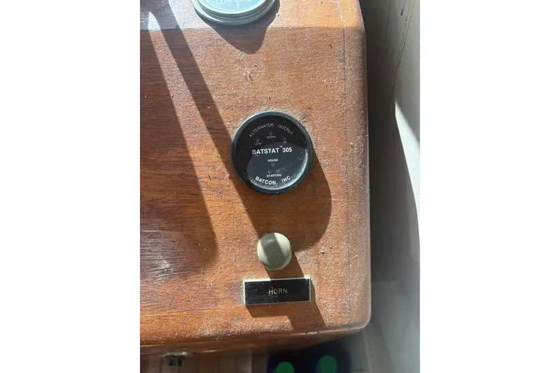 Slide: The Image of Control panel of a 1975 Gulfstar 43 Trawler with horn button and gauge. - 14