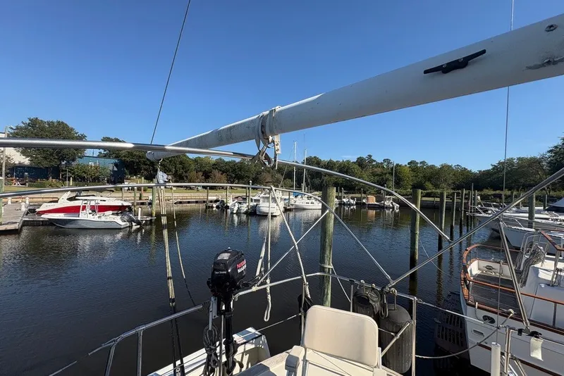 Slide: The Image of 1975 Gulfstar 43 Trawler docked in a serene marina setting. - 83