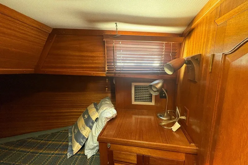 Slide: The Image of Cozy cabin interior of 1975 Gulfstar 43 Trawler with wooden furnishings and reading lamps. - 33