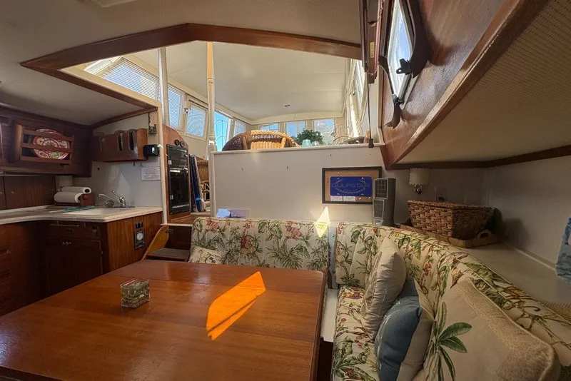Slide: The Image of Interior of a 1975 Gulfstar 43 Trawler with floral upholstery and wooden furnishings. - 43