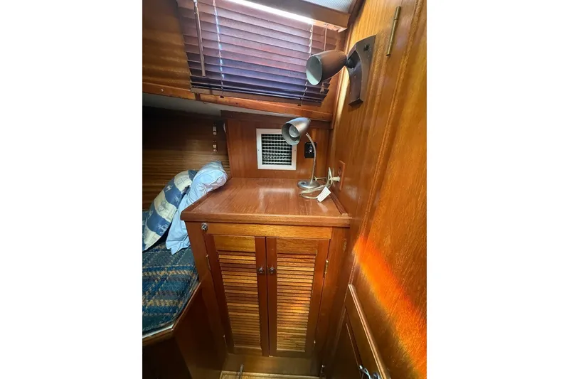 Slide: The Image of 1975 Gulfstar 43 Trawler cabin interior with wooden cabinetry and lighting fixtures. - 34
