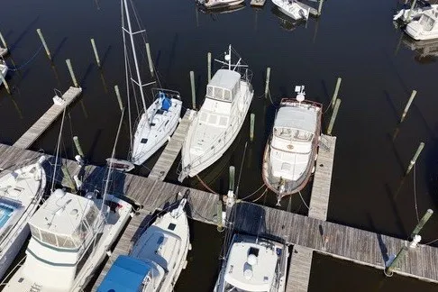 Slide: The Image of Aerial view of a 1975 Gulfstar 43 Trawler docked among other boats at a marina. - 94