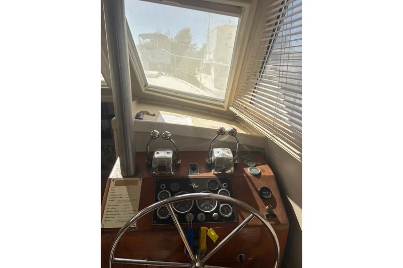 Slide: The Image of 1975 Gulfstar 43 Trawler helm with steering wheel and control panel. - 15