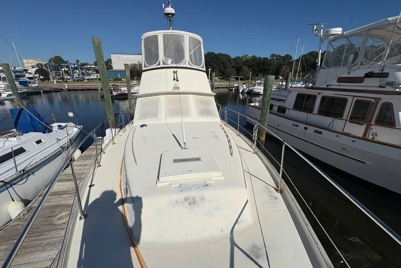 Slide: The Image of 1975 Gulfstar 43 Trawler docked at marina, surrounded by other boats. - 90