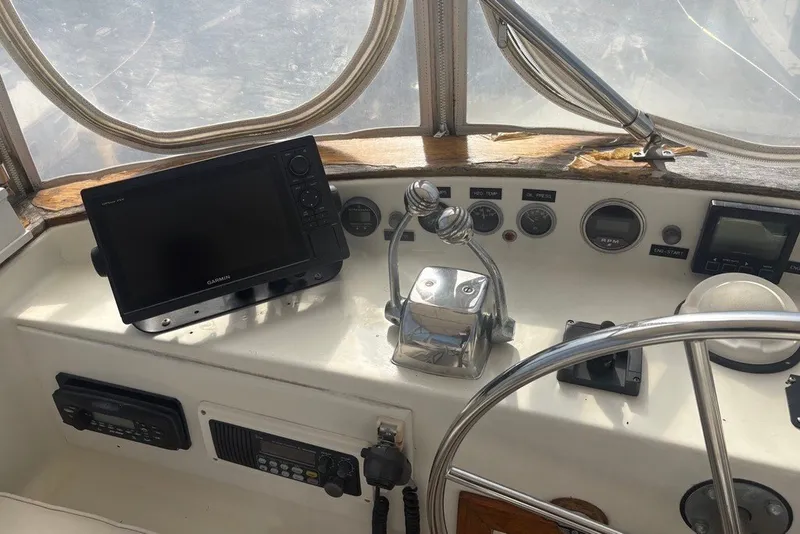 Slide: The Image of 1975 Gulfstar 43 Trawler helm with Garmin navigation and control instruments. - 72